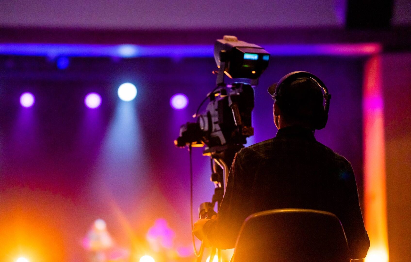 Person Sitting on a Chair in Front of a Video Camera